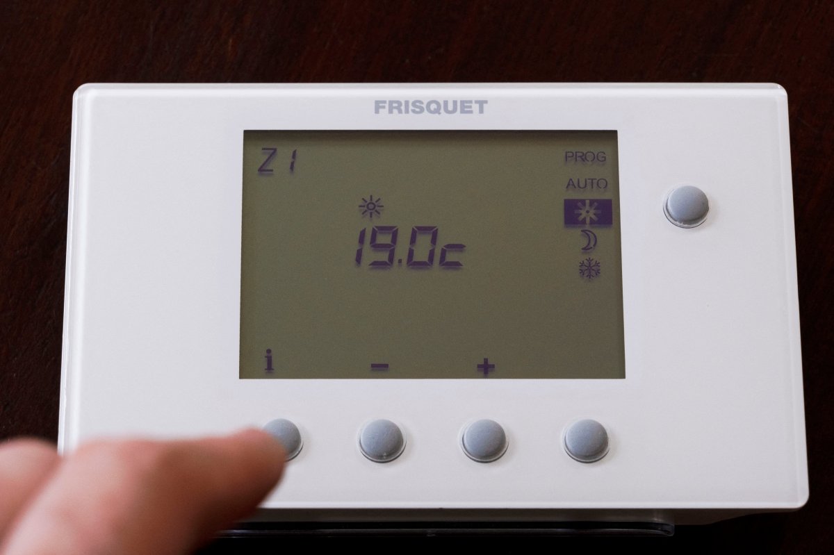 Adjusting a heating thermostat to a temperature of 19 C. 