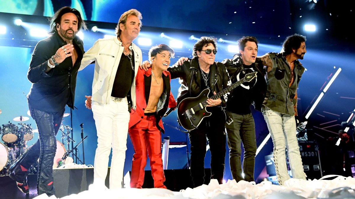 The members of Journey on stage.