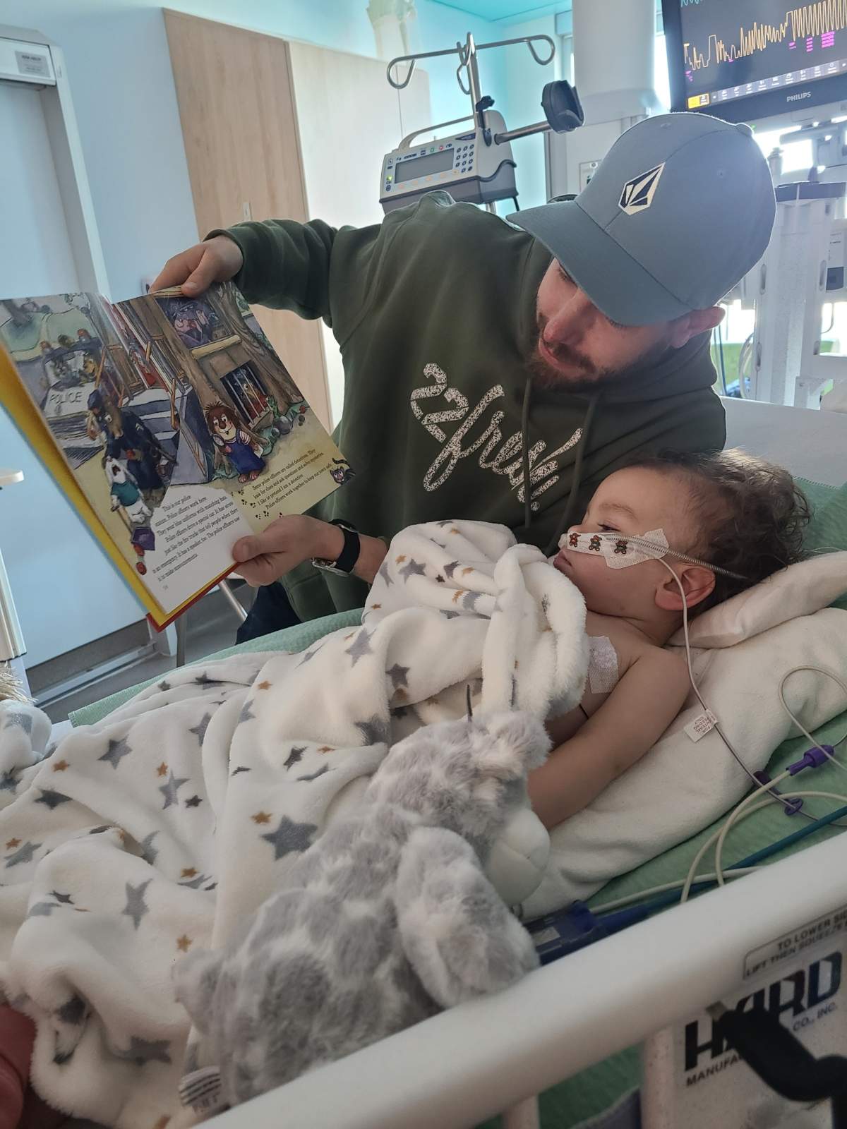 Matt Temple reading to his son Barrett while at the hospital.