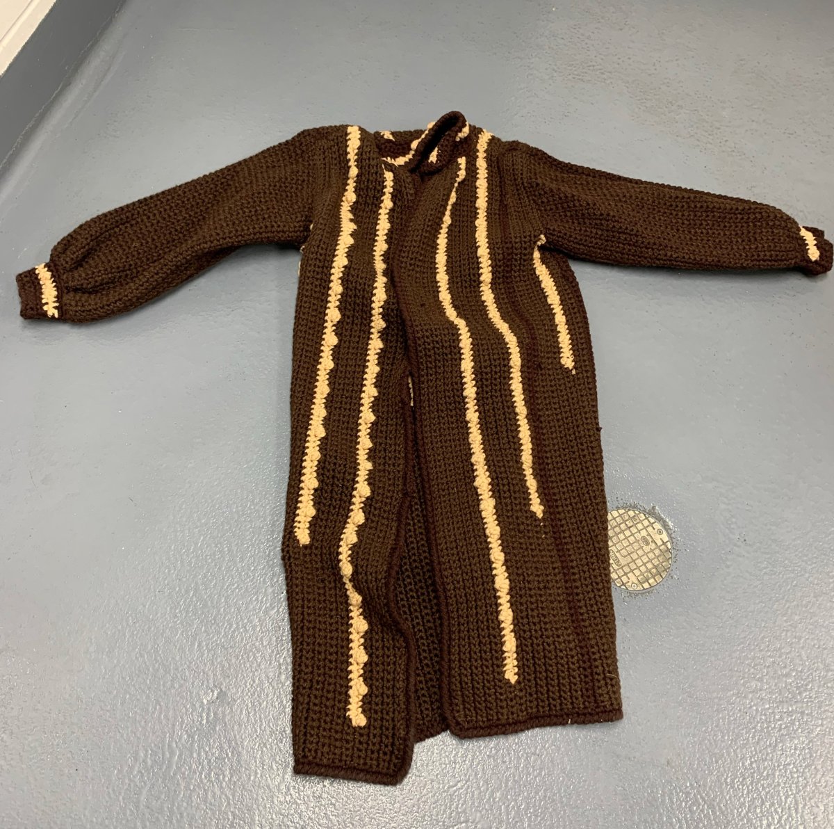 Knitted three-quarter-length coat believed to be stolen.