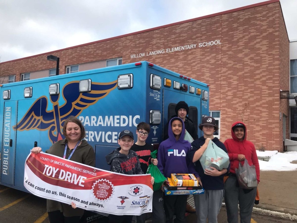 Willow Landing Elementary School students help load up donations, including 110 lbs of food, to the County of Simcoe Paramedic Services 20th Annual Drive.