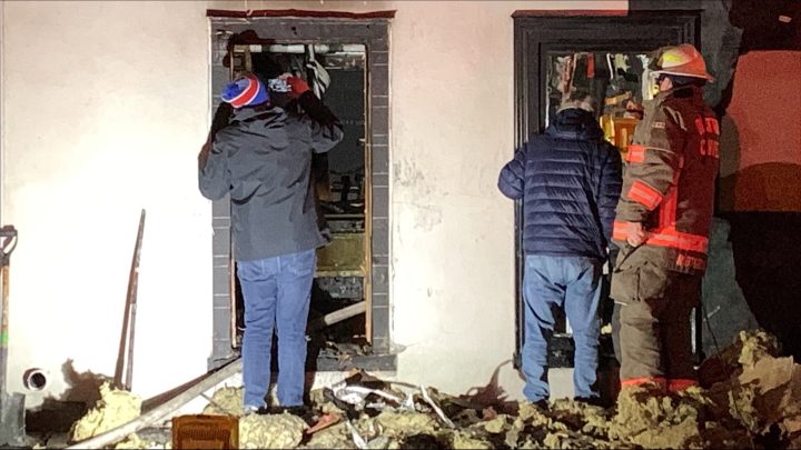 Matthew Rondina (left) and George Rondina examine damage after a fire at Number 9 Audio Group Saturday evening.