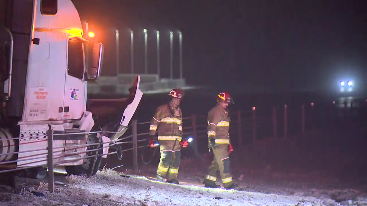 A photo of firefighters walking among the multi-vehicle crash scene on Highway 2 on Dec. 28, 2022.