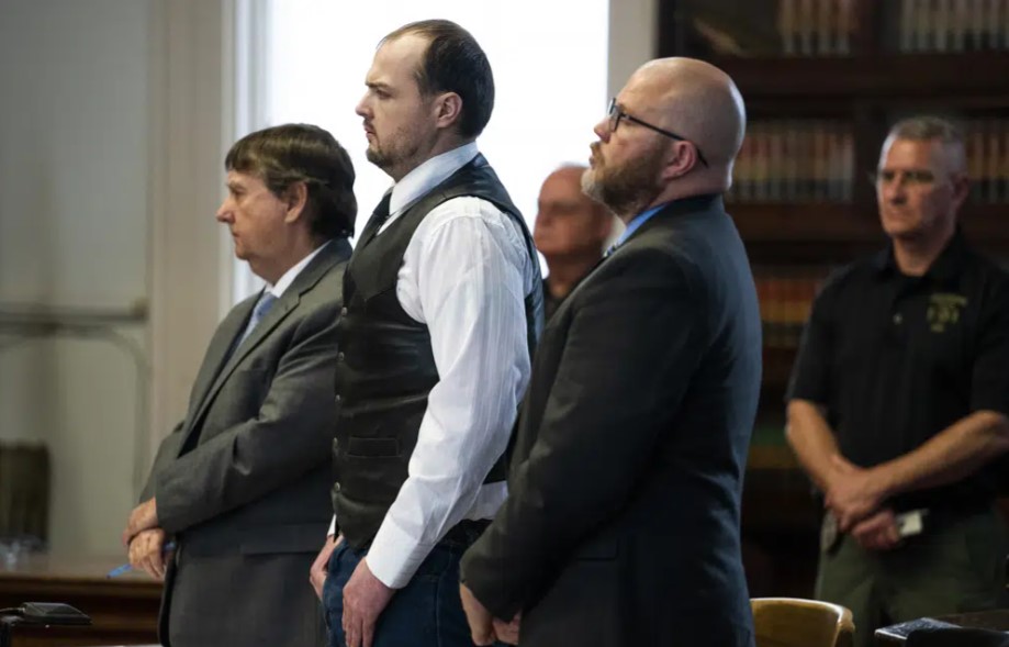 George Wagner IV, center, stands next to attorneys John P. Parker and Richard M. Nash while he receives his sentence from Judge Randy Deering at a hearing, Monday, Dec. 19, 2022, in Waverly, Ohio. Wagner who was convicted in the killings of eight members of an Ohio family was sentenced Monday to life in prison without the possibility of parole.