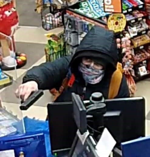 Pictures of the suspect released by police show a man holding a handgun at the counter of a business in the area of Parkinson Road and Norwich Avenue in Woodstock, Ont.
