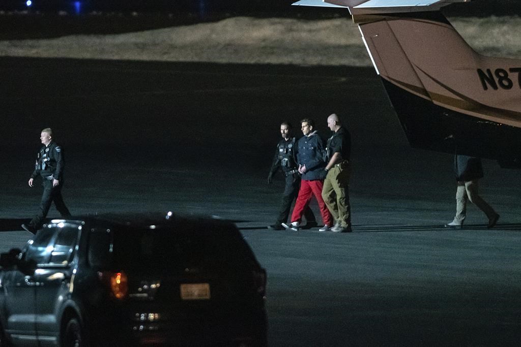 Bryan Kohberger is escorted by law enforcement after arriving at Pullman-Moscow Regional Airport on Thursday, Jan. 4, 2023, in Pullman, Wash.