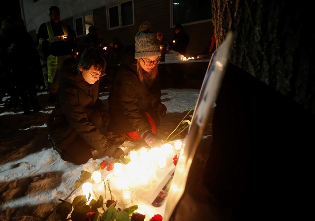 Kirstin Witwicki, right, a cousin of Morgan Harris, joined the family and friends of three slain women at a vigil in Winnipeg, Thursday, Dec. 1, 2022.
