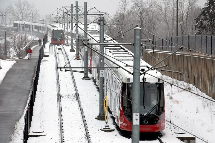 Stalled LRT OC Transpo trains are seen near Lees Avenue station in Ottawa, on Friday, Jan. 6, 2023. People who take public transit to work in Ottawa found part of the city's light rail transit line closed to start the week as the repairs continue after last week's ice storm. 