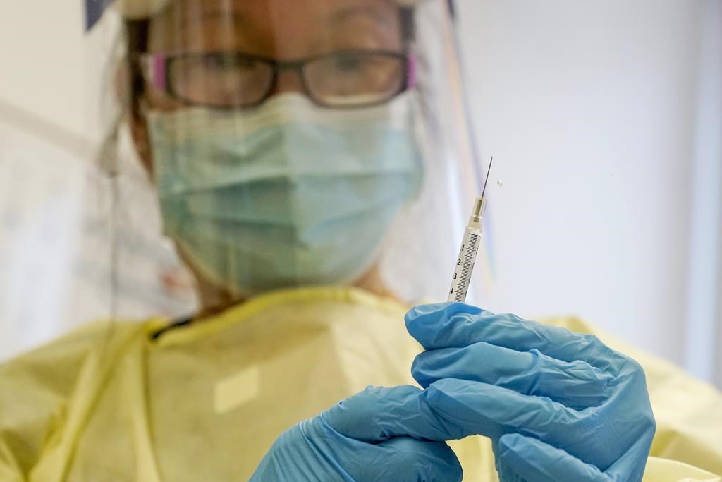 FILE - A physician assistant prepares a syringe with the Mpox vaccine for a patient at a vaccination clinic in New York on Friday, Aug. 19, 2022. 