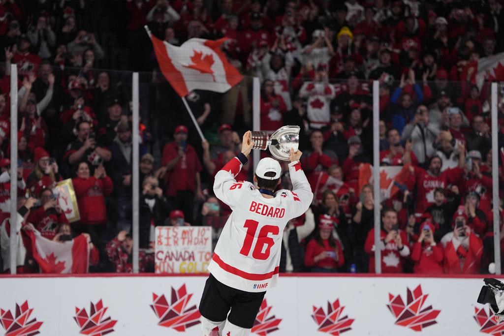 Canada’s Connor Bedard carries the IIHF Championship Cup while celebrating winning gold over Czechia during overtime of the IIHF World Junior Hockey Championship gold medal game in Halifax on Thursday, January 5, 2023.