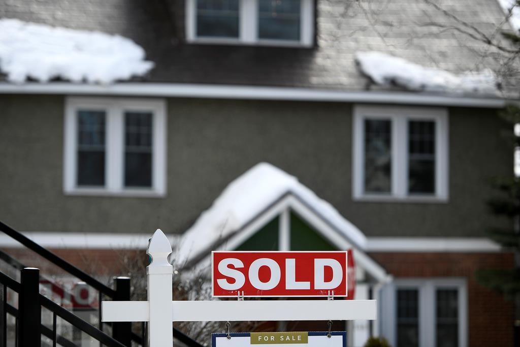 A for sale sign outside a home indicates that it has been sold, in Ottawa, on Monday, March 1, 2021. THE CANADIAN PRESS/Justin Tang.