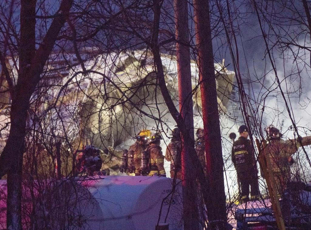 Firefighters work the scene after an explosion at a propane company, Thursday, January 12, 2023 in Saint-Roch-de-L’Achigan, Que. Three employees of a propane distribution business remain unaccounted for one day after an explosion and fire north of Montreal.