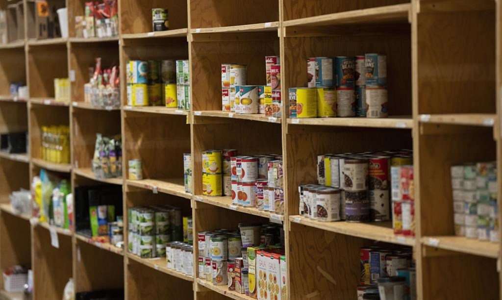 Canned products sit on shelves at a food bank in Ottawa, Friday, Oct. 7, 2022. 