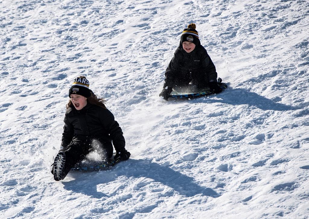 Kids go tobogganing at Lansdowne Park in Ottawa on Family Day, Monday, Feb. 17, 2020. A proposal to ban tobogganing at all but two municipal parks in a city east of Toronto is drawing criticism from lawyers who say the plan won’t boost safety but could limit access to the popular winter pastime. 