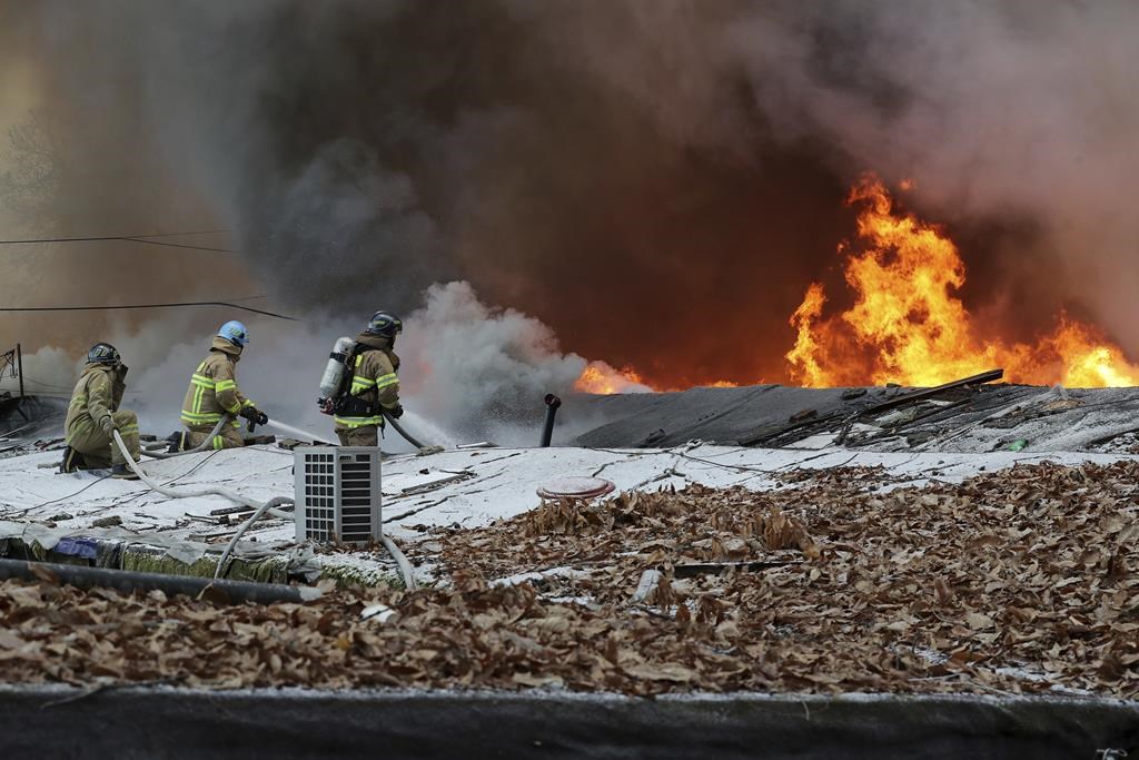 Firefighters battle a fire at Guryong village in Seoul, South Korea, Friday, Jan. 20, 2023. About 500 South Koreans were forced to flee their homes after a fire spread through a low-income neighborhood in southern Seoul on Friday morning and destroyed dozens of homes. (Baek Dong-hyun/Newsis via AP).