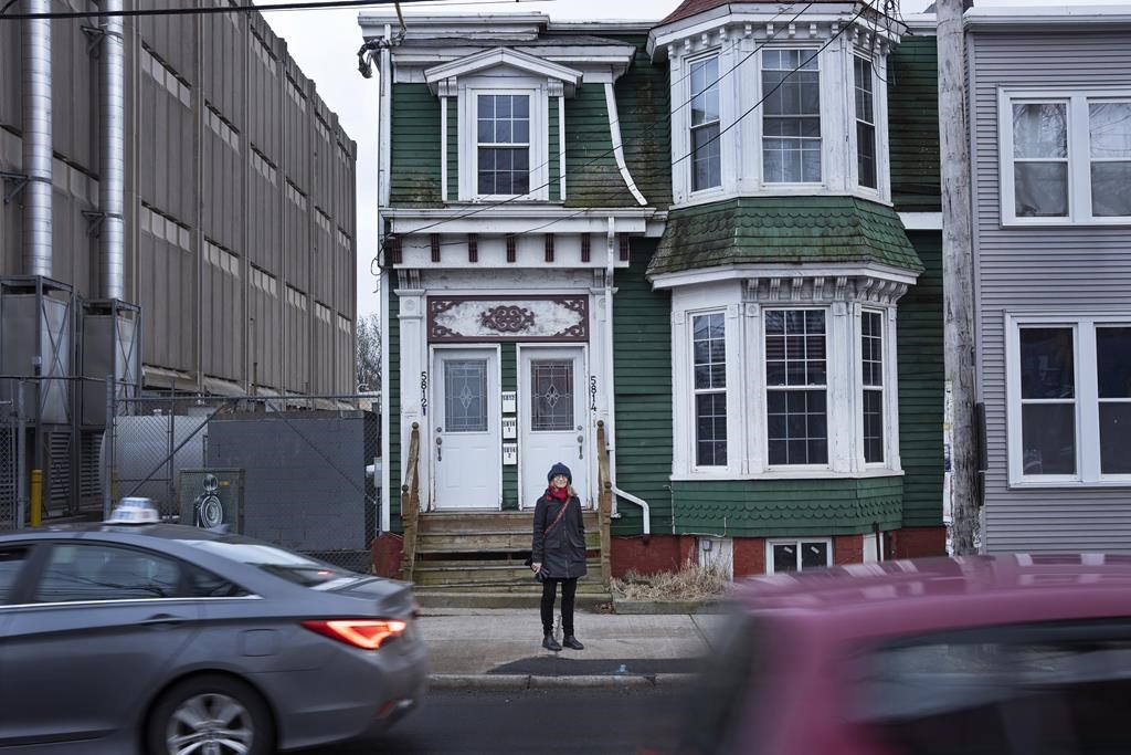 Peggy Cameron, from the non-profit Friends of Halifax Common, stands in front of a stately home that the group is seeking heritage designation to save it from demolition in Halifax on Thursday, January 19, 2023. The home was owned by Dr. Clement Ligoure, the first Black doctor in Nova Scotia, where Dr. Ligoure operated his clinic in the early 1900s—treating hundreds of people injured by the Halifax Explosion on Dec. 6, 1917.