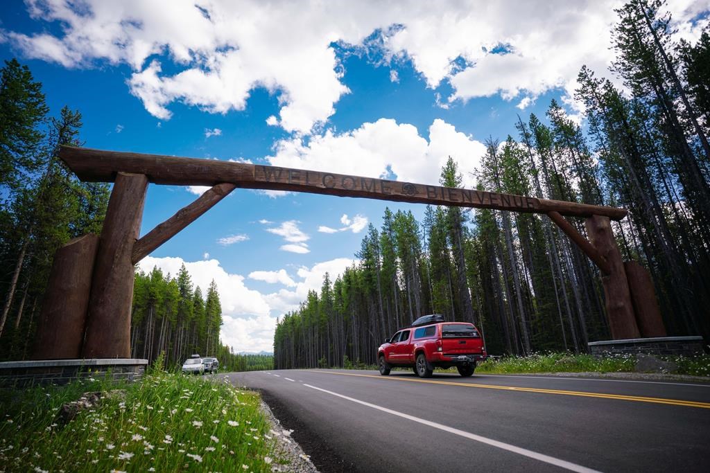 A vehicle drives under the welcome sign on Highway 1A, also known as the Bow Valley Parkway, in Banff National Park in 2020 as seen in this handout image provided January 23, 2023. THE CANADIAN PRESS/HO-Parks Canada **MANDATORY CREDIT**.