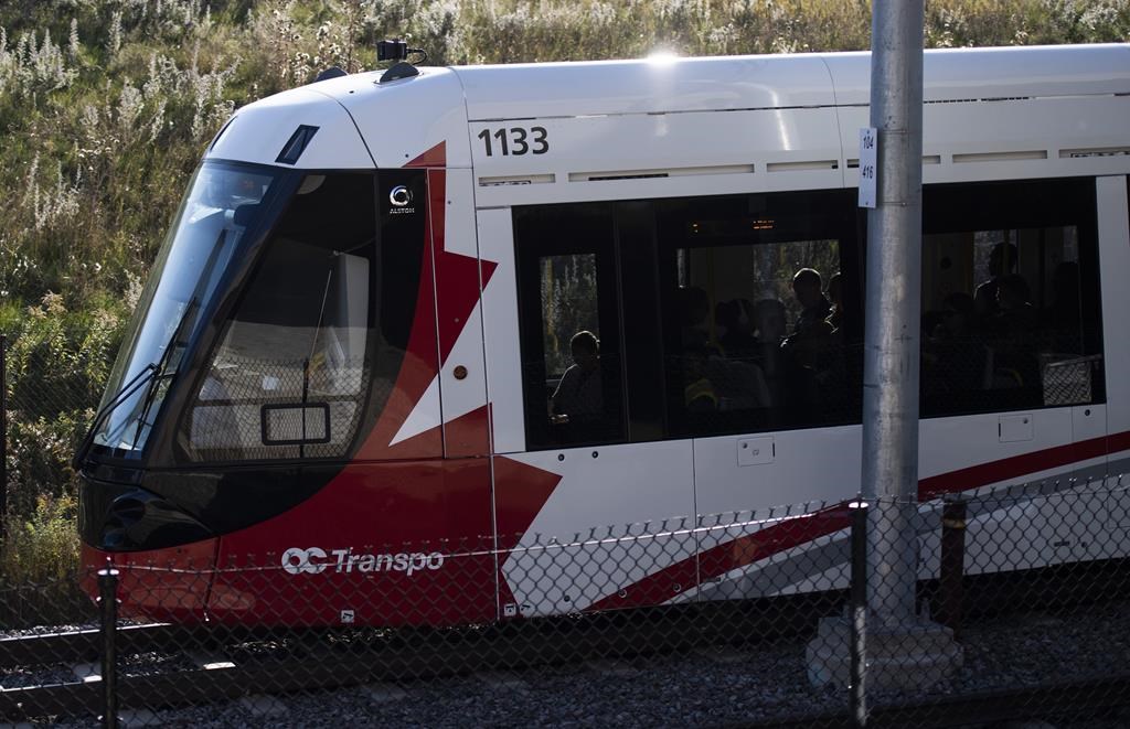 Passengers ride an LRT train on OC Transpo's new O-Train Confederation Line in Ottawa, on Friday, Oct. 11, 2019. The City of Ottawa has ratified the settlement agreement with Rideau Transit group after disputes over the light rail transit system. THE CANADIAN PRESS/Justin Tang.