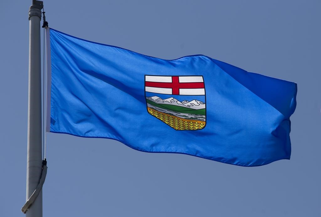Alberta's provincial flag flies on a flagpole in Ottawa, on Monday July 6, 2020. A bail hearing for a mother and father in southern Alberta facing charges after police say their six-week-old child was physically and sexually assaulted has been delayed