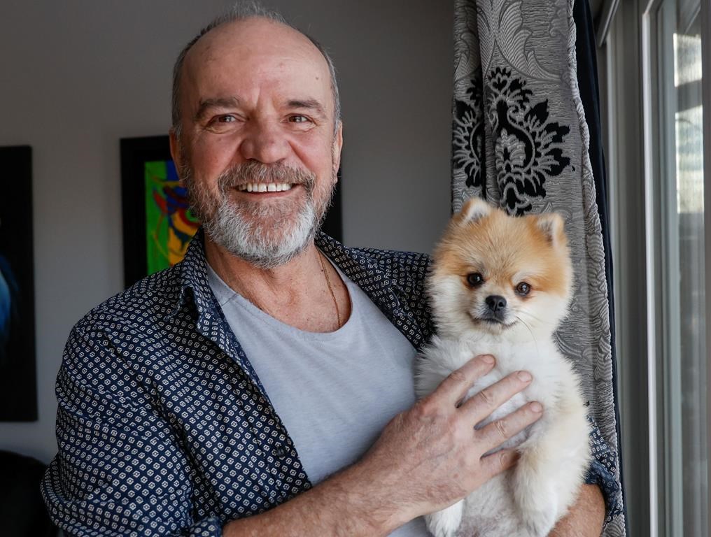 Ivo Ceko holds his dog Charlie at his home in Calgary, Alta., Monday, Jan. 30, 2023.