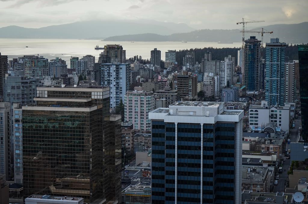Home sales in Greater Vancouver are predicted to stay in line with last year’s slower pace, while prices will inch up slightly. Office towers, condos and apartment buildings are seen in downtown and the West End of Vancouver, on Thursday, Jan. 19, 2023. THE CANADIAN PRESS/Darryl Dyck.