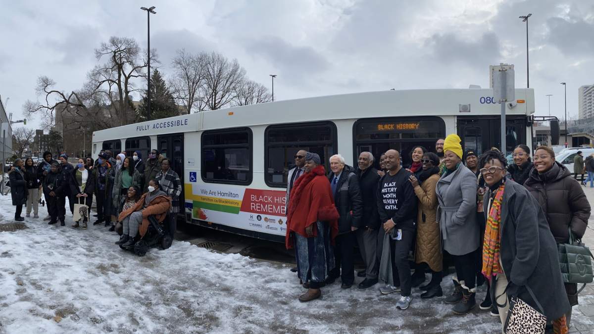 Organizers and speakers at the launch of Hamilton’s “Black History Remembered” pose in front of an HSR bus bearing imagery linked to the initiative – one of twelve buses that will be rolling around the city for the next sixteen weeks.