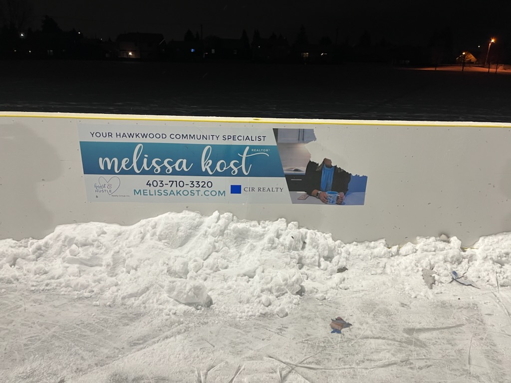 Damage to a rink board ad at the Hawkwood community outdoor rink in Calgary.