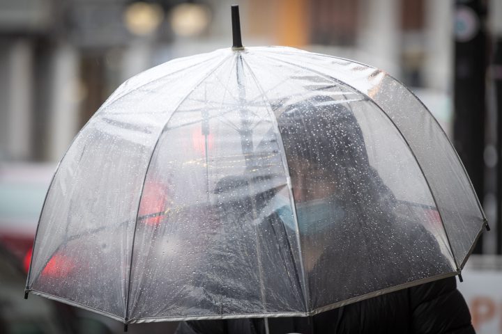 A person carries an umbrella during a rainy day.