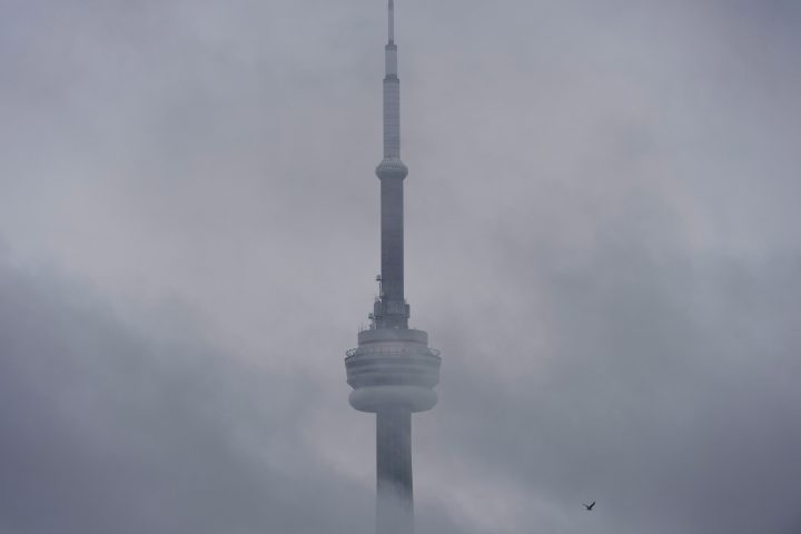 The CN Tower hides behind the clouds during a foggy morning in Toronto on Wednesday, June 27, 2018. 