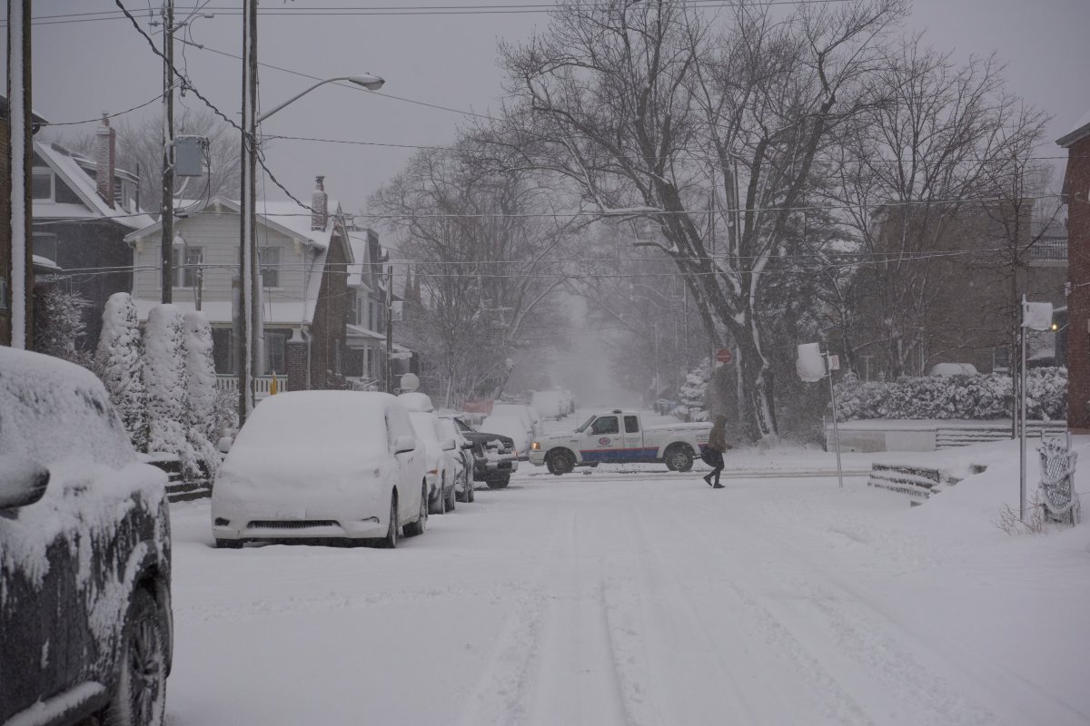 A CAA truck drives down Pape Avenue during a heavy winter snowstorm, Toronto, Ont., Jan. 25, 2023. 