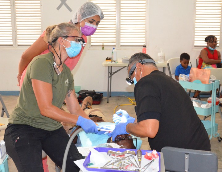 Canadian dental workers at a free clinic in Grenada.