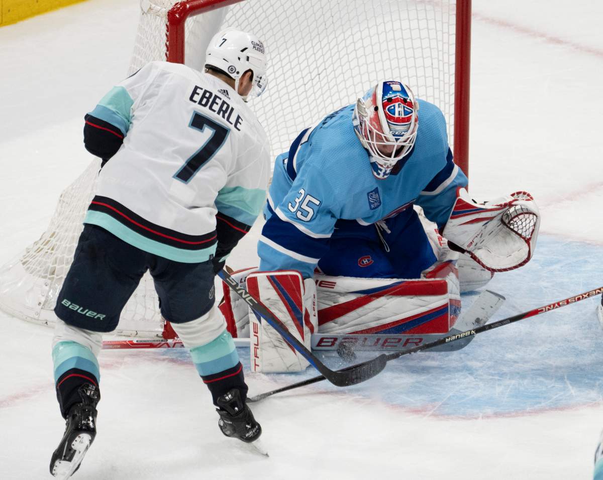Montreal Canadiens goaltender Sam Montembeault (35) makes the save on Seattle Kraken’s Jordan Eberle (7) during second-period NHL hockey action Monday, Jan. 9, 2023, in Montreal.