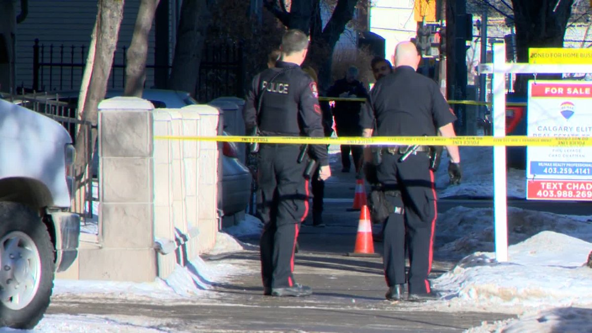 Calgary police officers investigate an area in the city's Beltline neighbourhood following a midmorning shooting on Jan. 6, 2023.