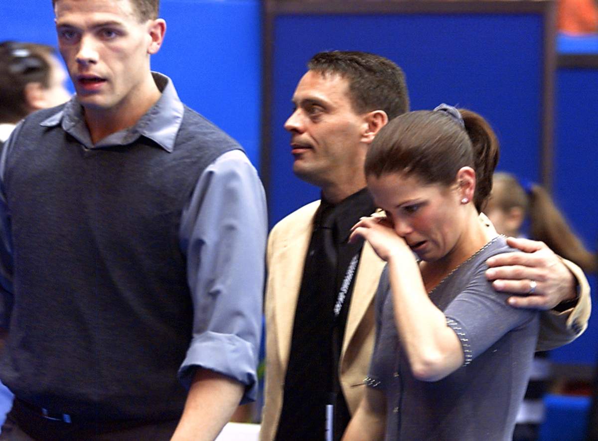 Canadian Jamie Sale is comforted by her coach Richard Gauthier after her free program during the World Figure Skating Championships in Nice 29 March 2000. 
