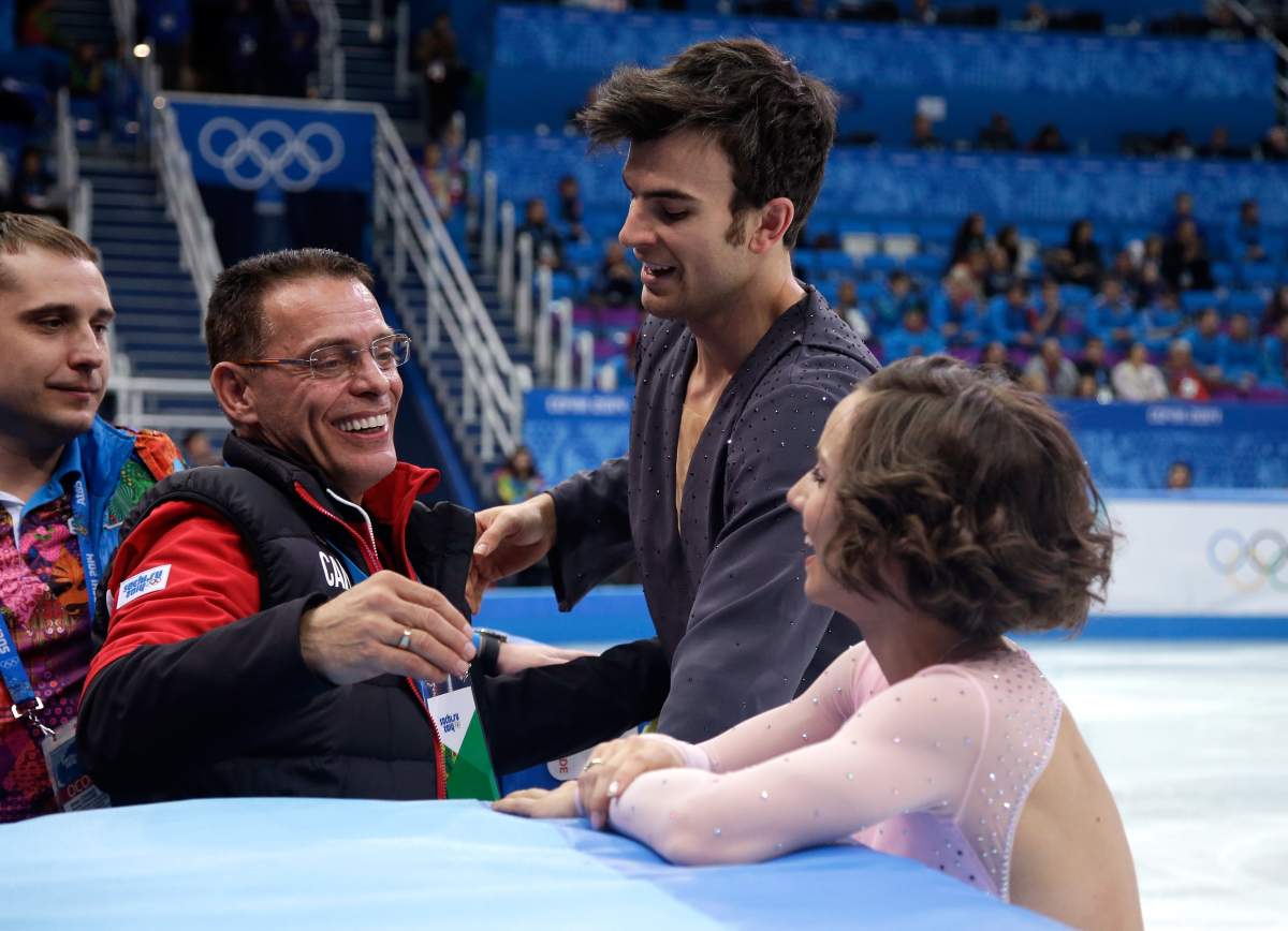Meagan Duhamel and Eric Radford of Canada hug coach Richard Gauthier (L) after competing in the Figure Skating Pairs Short Program during the Sochi 2014 Winter Olympics at Iceberg Skating Palace on February 6, 2014 in Sochi, Russia.