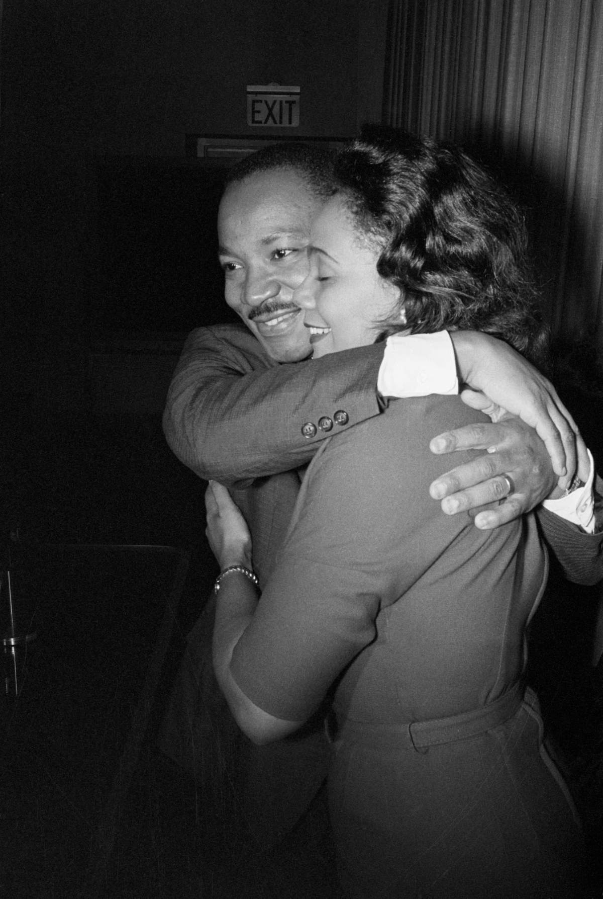 Martin Luther King Jr. and Coretta Scott King hug in this black and white photo.