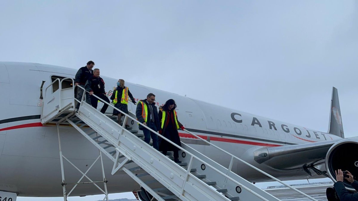 Minister of Transport Omar Alghabra and  Hamilton West–Ancaster–Dundas MP Filomena Tassi at Hamilton disembark from a CargoJet plane at Hamilton's international airport on Jan 23, 2023.

