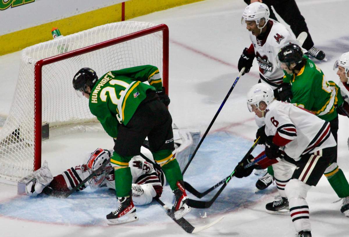Ryan Humphrey of the London Knights digs for a puck.