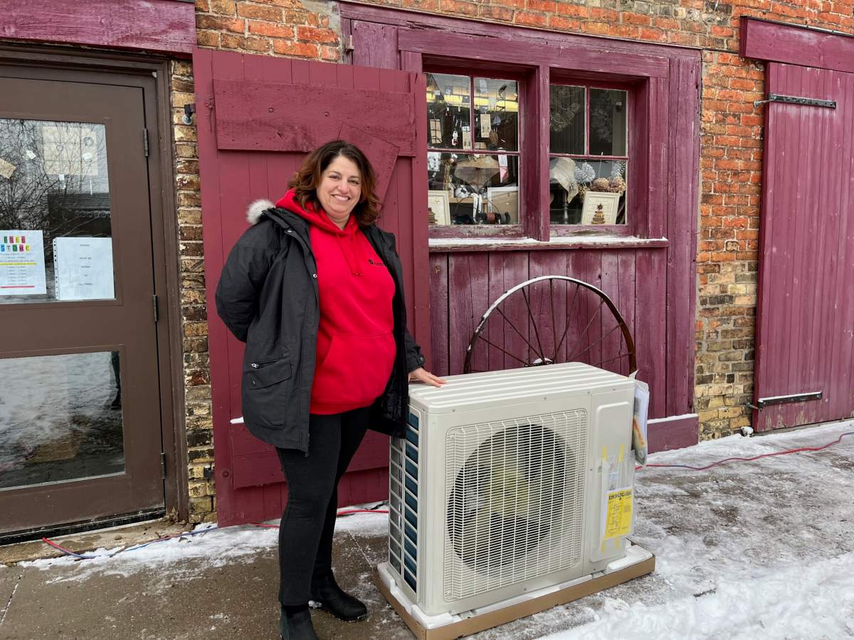 Anna Donaldson poses with the new heating/air conditioning unit being donated by Donaldson Home Services.