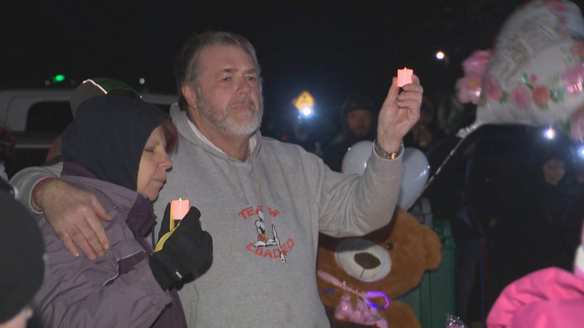 People hold candles at a Lethbridge vigil for a six-week-old baby who is in critical condition after she was allegedly assaulted and sexually assaulted. Jan. 23, 2023.