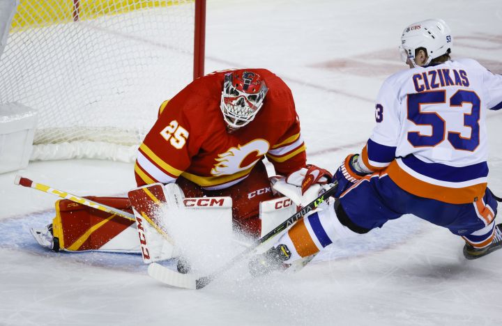 New York Islanders forward Casey Cizikas, right, tries to score on a breakaway as Calgary Flames goalie Jacob Markstrom blocks him during second period NHL hockey action in Calgary, Friday, Jan. 6, 2023.