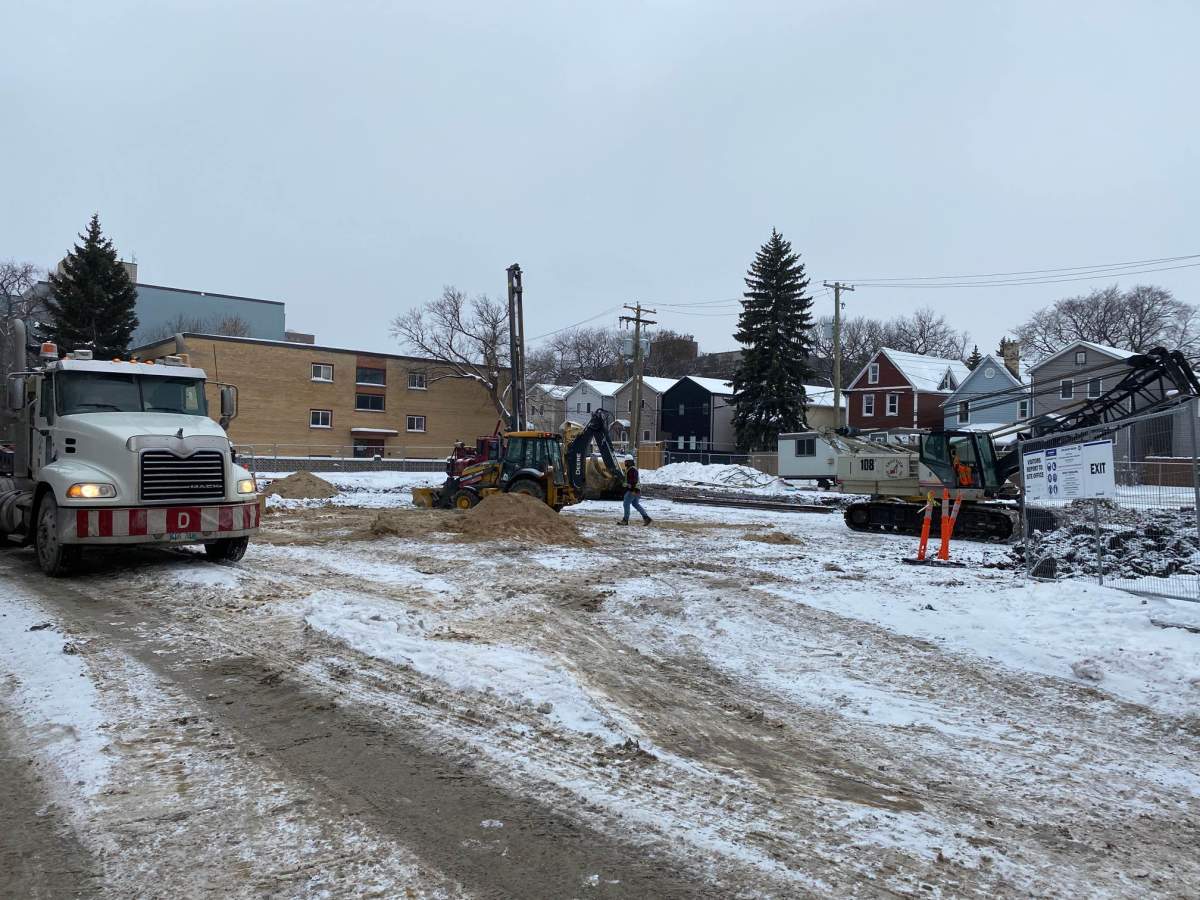 Construction crews at the site of the announced apartment complex.