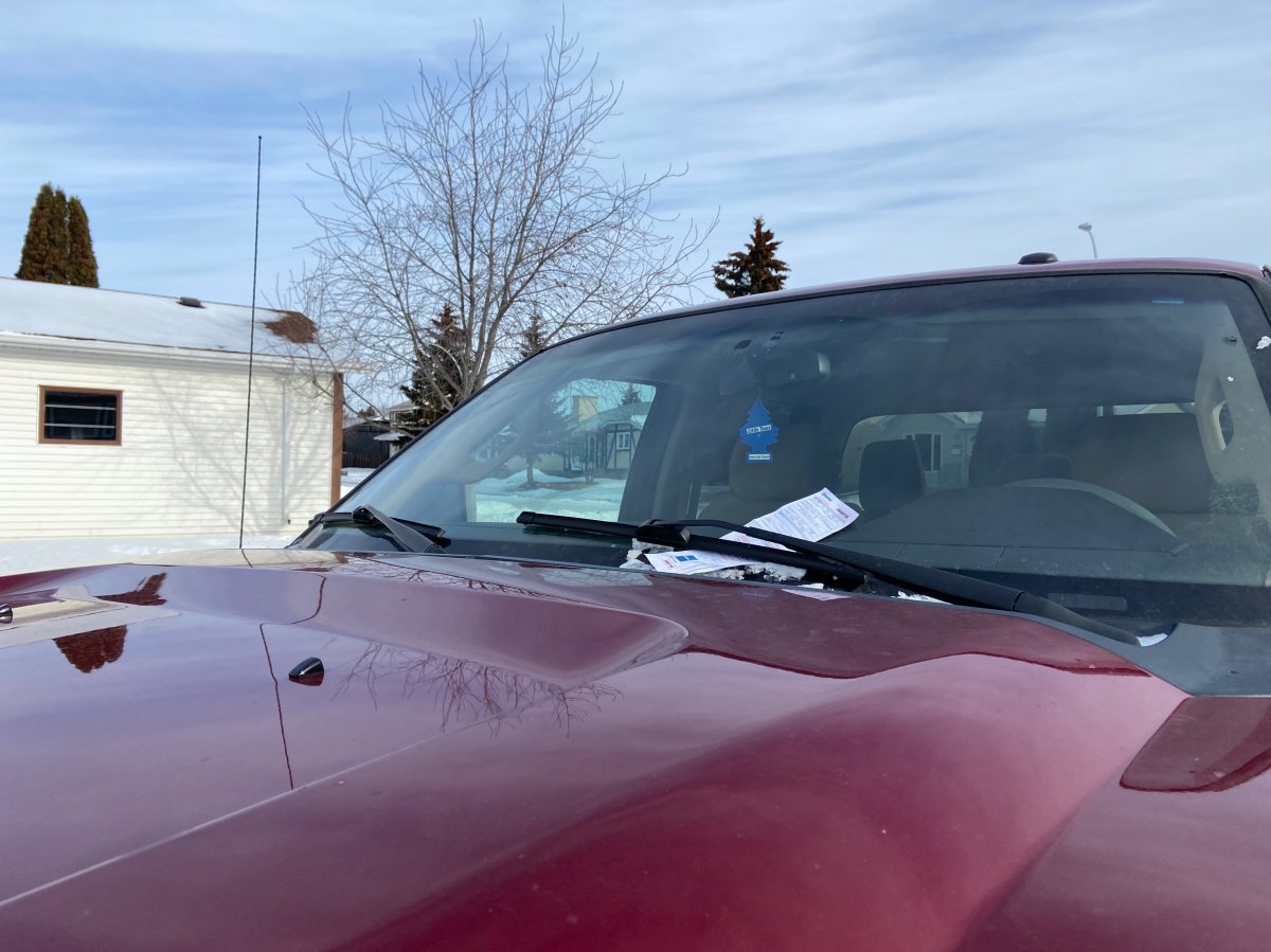 A parking ticket sits on the windshield of a truck after it failed to move during a Phase 2 parking ban.