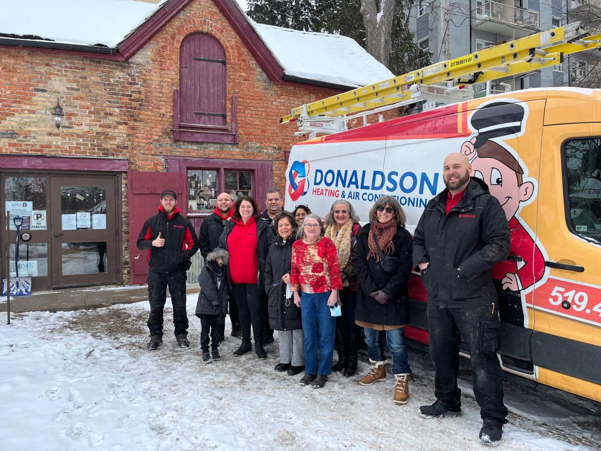 Staff from Donaldson Home Services are joined by members of the Micro Enterprise program as a new heating/air conditioning is delivered to My Sisters' Place.