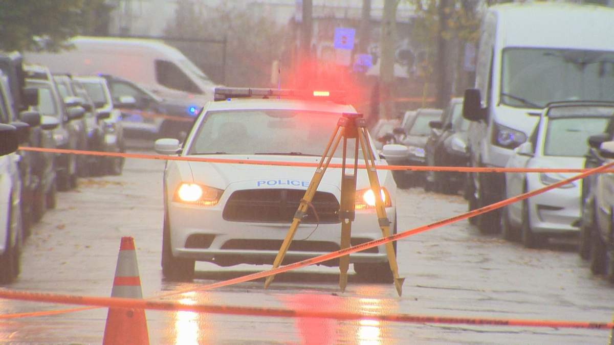 SPVM officers survey the scene of a fatal collision in Montreal.