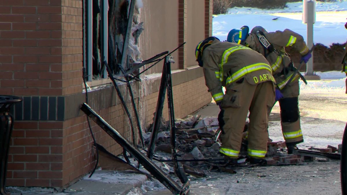 Investigators comb through evidence of a fire at a Calgary restaurant on Jan. 5, 2023.