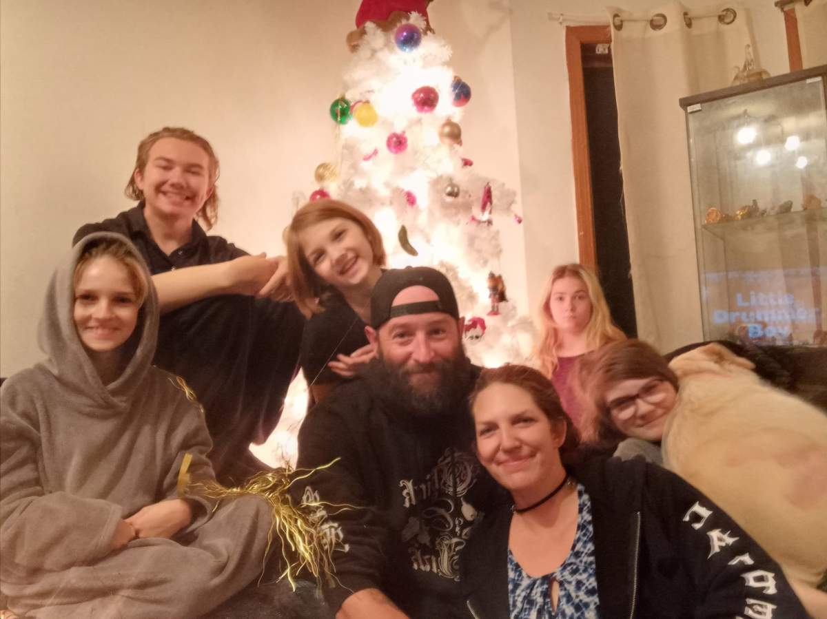 Christmas 2022, the last Christmas together for Angela McKenzie (front, second from left), Jeff Poirier (centre) and family.
