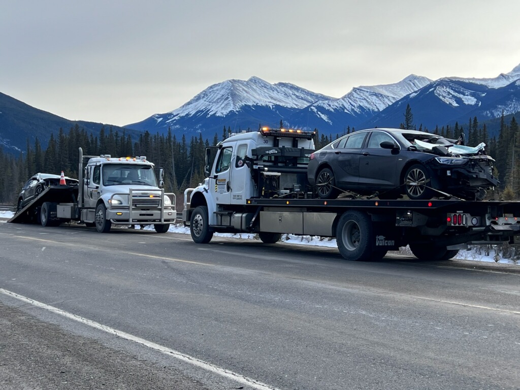 Two vehicles involved in a fatal head-on collision on tow trucks outside Canmore, Alta. Sunday, Jan. 15, 2023.