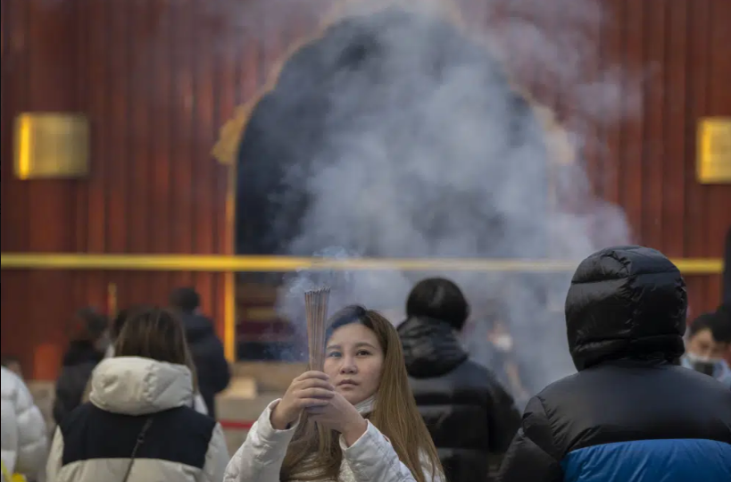 Chinese pray for health in Lunar New Year as Covid death toll rises