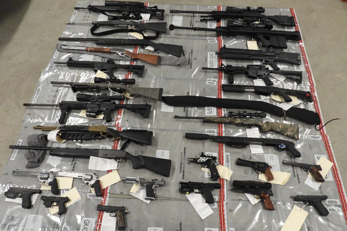 Officers did a search of the entire home, which netted a total haul of 17 long guns, 12 handguns, 14,500 rounds of ammunition and multiple prohibited devices.